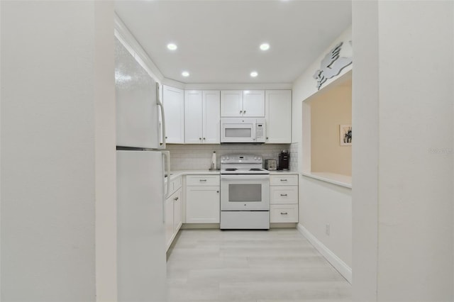 kitchen with decorative backsplash, light wood-type flooring, white appliances, and white cabinetry