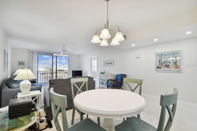 dining room with ceiling fan with notable chandelier