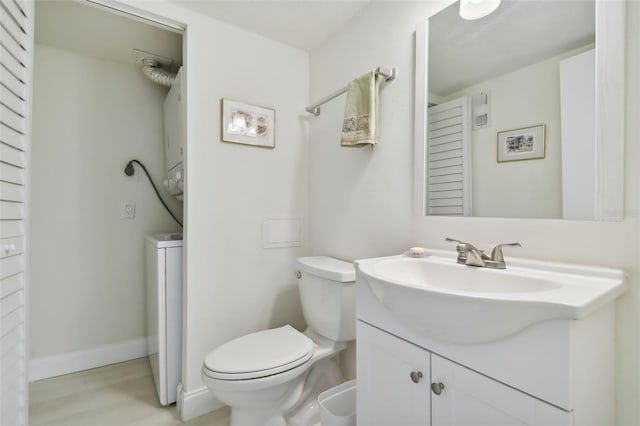 bathroom featuring vanity, hardwood / wood-style flooring, and toilet