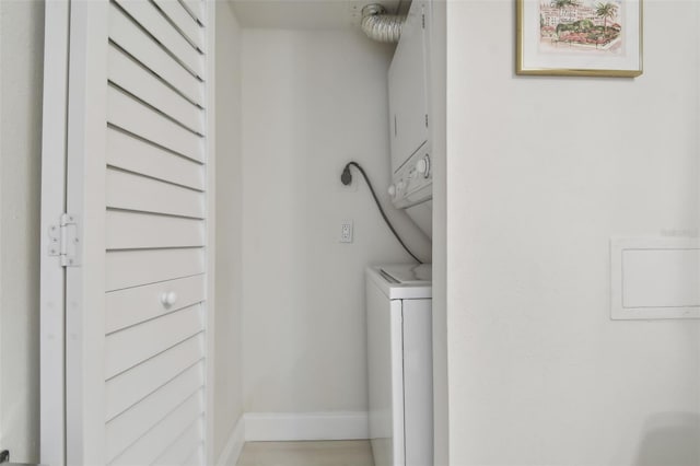 washroom with stacked washer / dryer