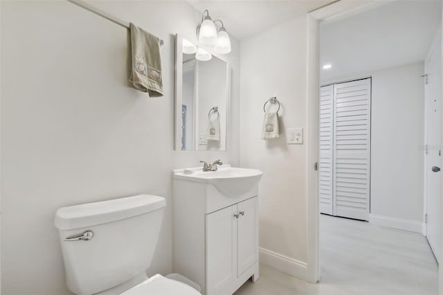 bathroom featuring hardwood / wood-style floors, vanity, and toilet