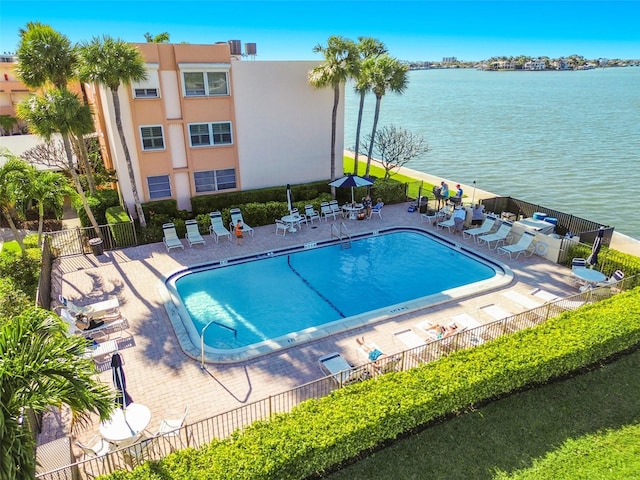 view of pool with a water view and a patio area