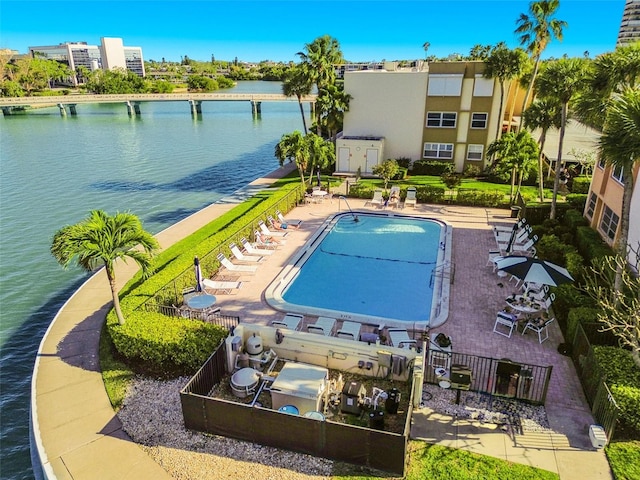 view of pool with a patio and a water view