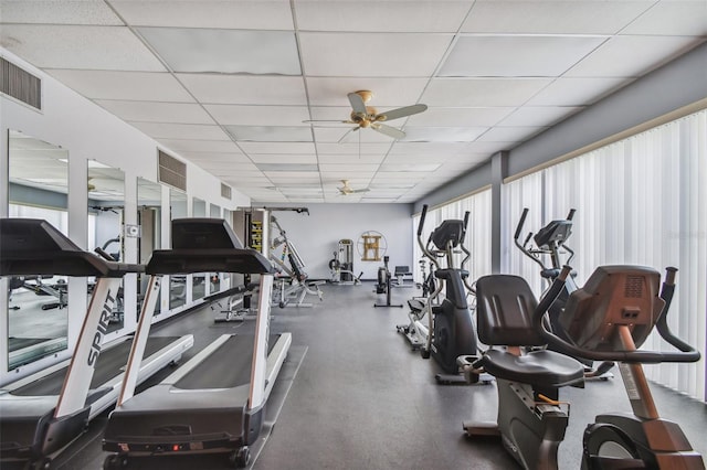 gym with a drop ceiling and ceiling fan