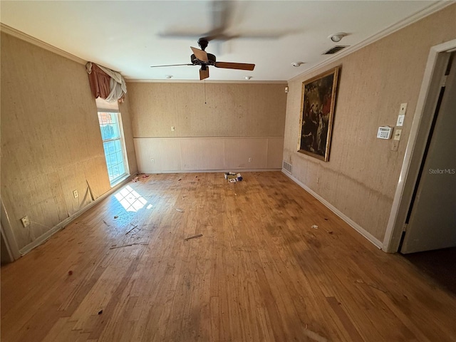 unfurnished room with wood-type flooring, ceiling fan, and crown molding