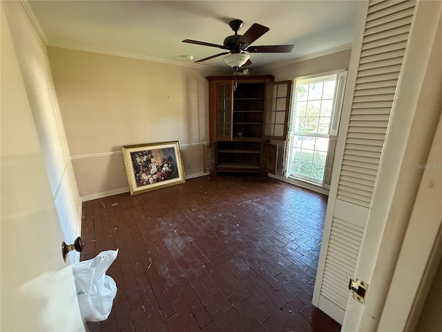 unfurnished living room featuring crown molding and ceiling fan