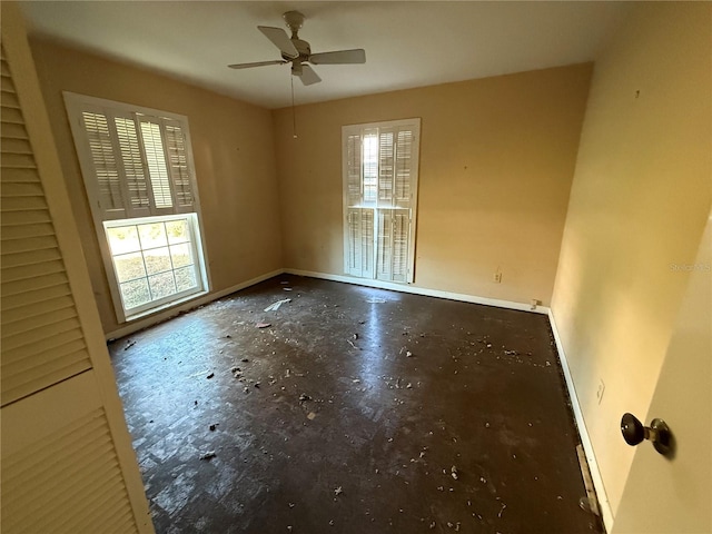 empty room featuring ceiling fan and a healthy amount of sunlight