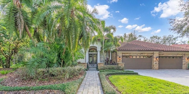 mediterranean / spanish-style home with french doors and a garage