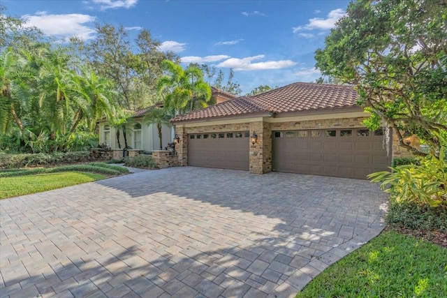 mediterranean / spanish home featuring a garage