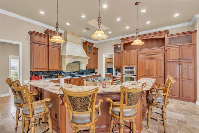 kitchen featuring decorative light fixtures, light stone counters, a kitchen bar, and double oven