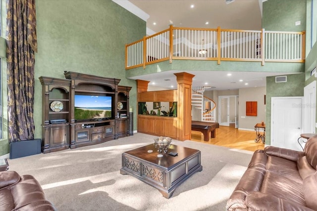 living room with hardwood / wood-style flooring and a high ceiling