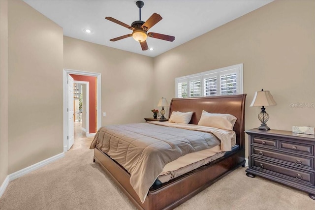 carpeted bedroom featuring multiple windows, ensuite bath, and ceiling fan