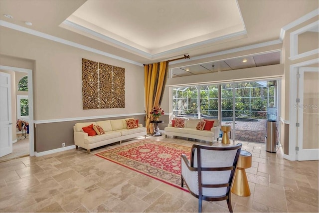 living room featuring a tray ceiling and crown molding