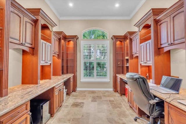 office space featuring built in desk and crown molding