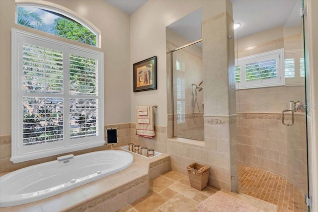 bathroom featuring shower with separate bathtub and a wealth of natural light