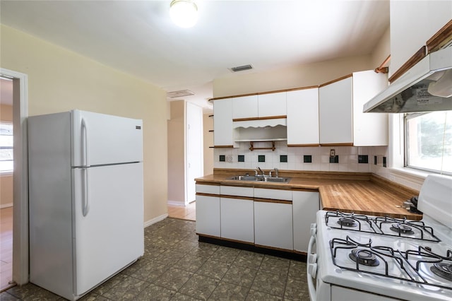 kitchen with white cabinets, white appliances, tasteful backsplash, and sink