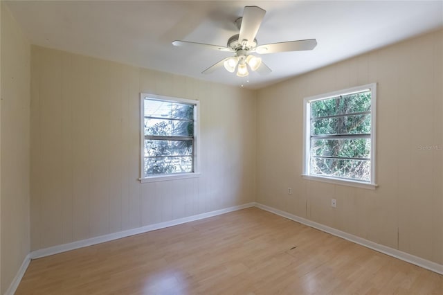 unfurnished room featuring ceiling fan, a healthy amount of sunlight, and light wood-type flooring