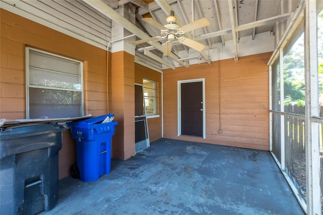 unfurnished sunroom with ceiling fan and a healthy amount of sunlight