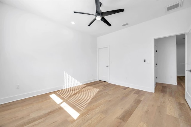 empty room featuring ceiling fan and light hardwood / wood-style flooring