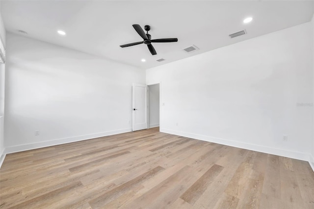 spare room featuring light wood-type flooring and ceiling fan