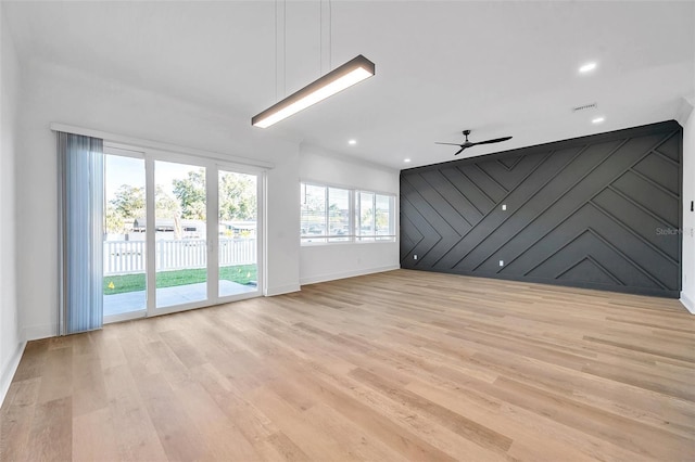 empty room featuring ceiling fan and light hardwood / wood-style flooring