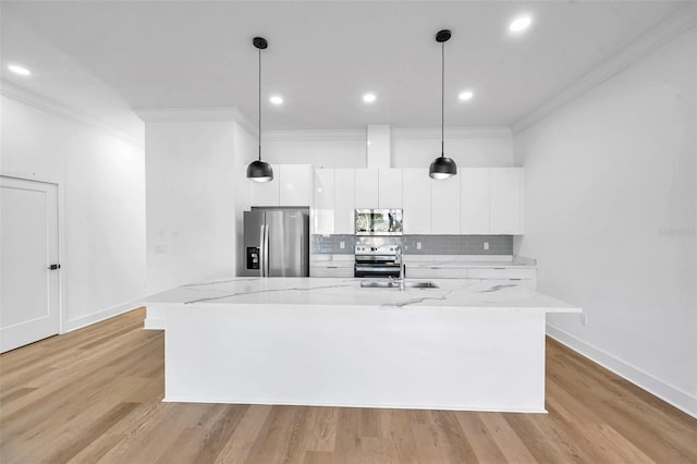 kitchen featuring decorative light fixtures, decorative backsplash, stainless steel appliances, and white cabinetry