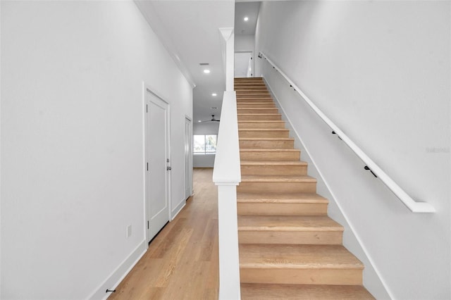 staircase with hardwood / wood-style flooring