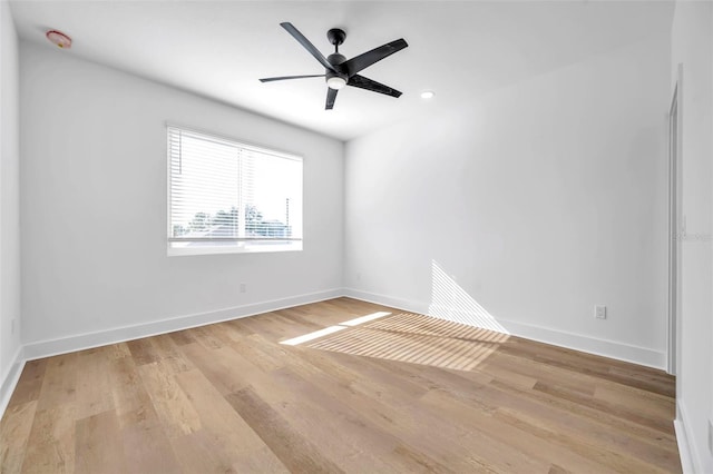 empty room with ceiling fan and light wood-type flooring