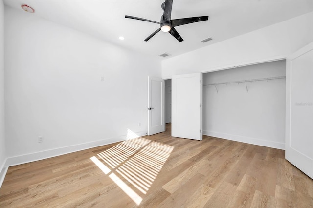 unfurnished bedroom featuring ceiling fan, a closet, and light hardwood / wood-style flooring