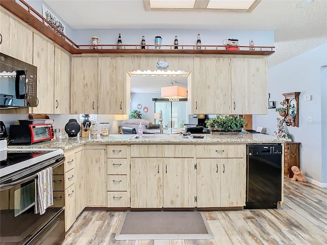 kitchen featuring light brown cabinets, black appliances, sink, a textured ceiling, and light hardwood / wood-style floors