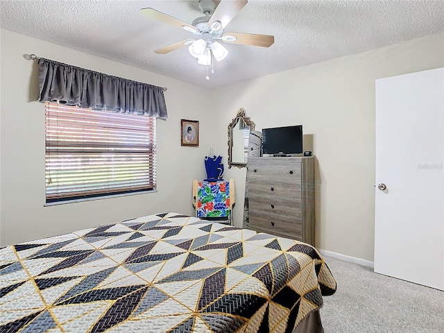 bedroom with carpet flooring, a textured ceiling, and ceiling fan