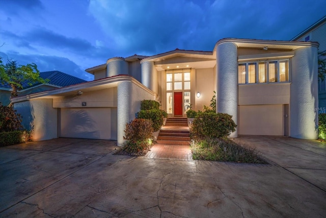 18 Winston Dr, Belleair, FL 33756 - view of front facade with concrete driveway, stucco siding, and an attached garage