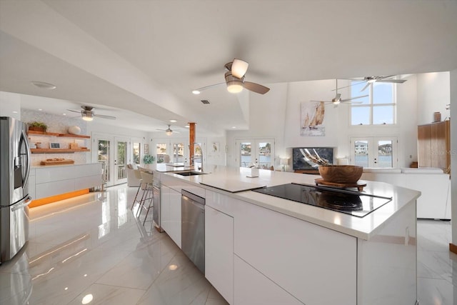 18 Winston Dr, Belleair, FL 33756 - kitchen featuring stainless steel appliances, open floor plan, light marble finish floors, white cabinetry, and recessed lighting