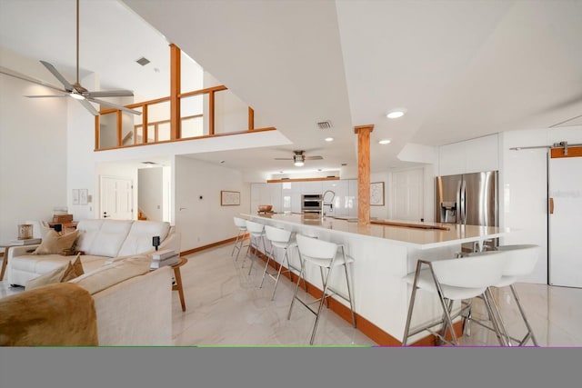 18 Winston Dr, Belleair, FL 33756 - kitchen featuring ceiling fan, stainless steel appliances, light marble finish floors, open floor plan, and recessed lighting