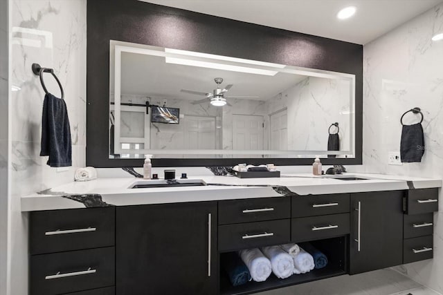 18 Winston Dr, Belleair, FL 33756 - full bathroom featuring marble look tiles, double vanity, and a ceiling fan