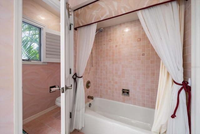 bathroom featuring toilet, shower / tub combo with curtain, and tile patterned flooring