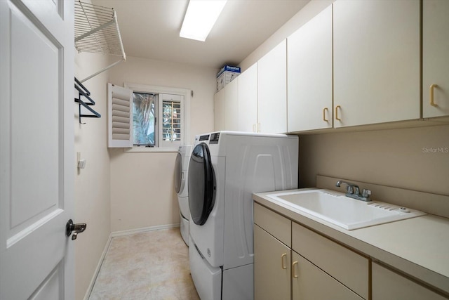 laundry room with sink, cabinets, and independent washer and dryer