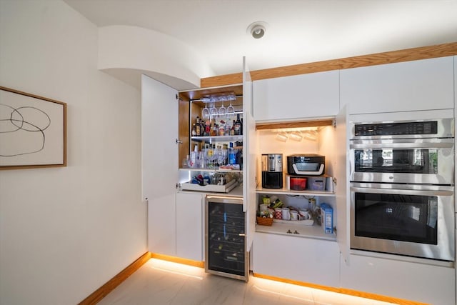 18 Winston Dr, Belleair, FL 33756 - indoor bar featuring wine cooler, double oven, and baseboards