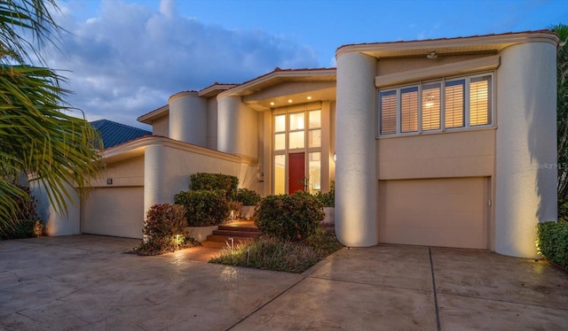 18 Winston Dr, Belleair, FL 33756 - art deco home featuring driveway, stucco siding, an attached garage, and a tile roof