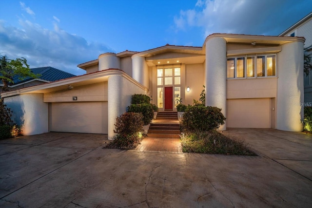 18 Winston Dr, Belleair, FL 33756 - art deco home featuring driveway, stucco siding, and an attached garage