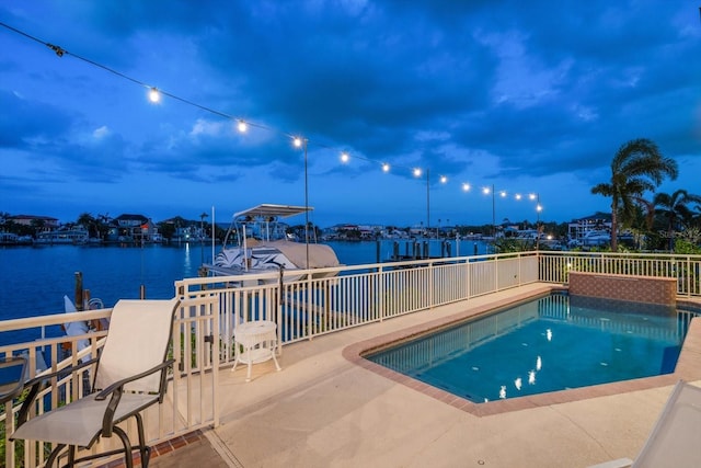 pool at dusk with a water view