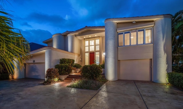 18 Winston Dr, Belleair, FL 33756 - art deco home with driveway, stucco siding, and a garage