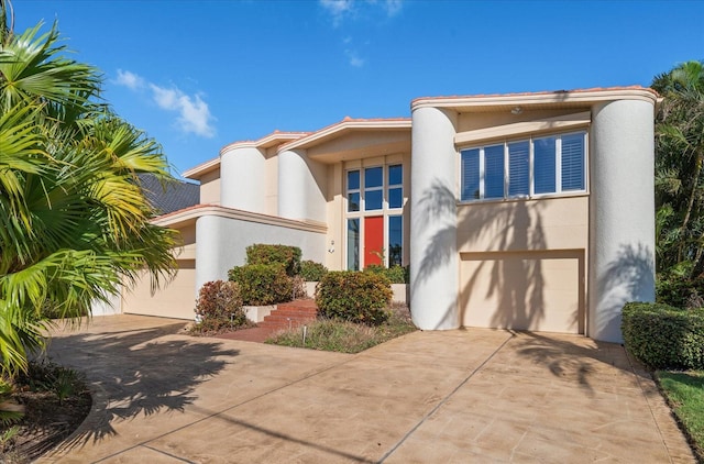 18 Winston Dr, Belleair, FL 33756 - art deco inspired home with driveway, an attached garage, and stucco siding