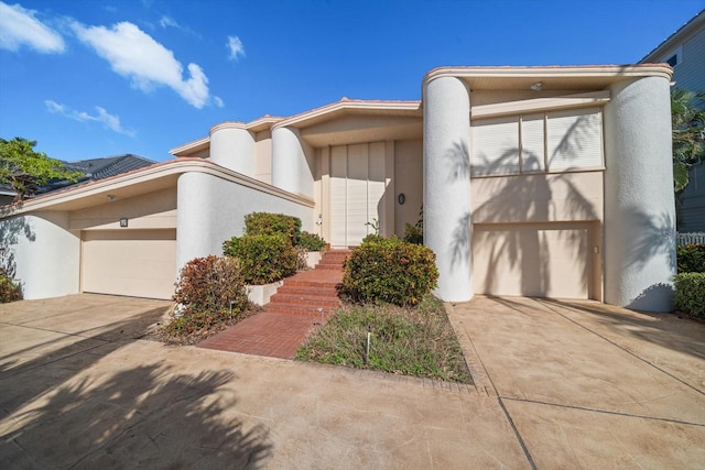 18 Winston Dr, Belleair, FL 33756 - art deco inspired home featuring driveway, stucco siding, and a garage