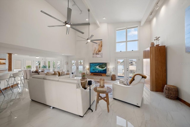 18 Winston Dr, Belleair, FL 33756 - living area featuring french doors, rail lighting, ceiling fan, light marble finish floors, and high vaulted ceiling