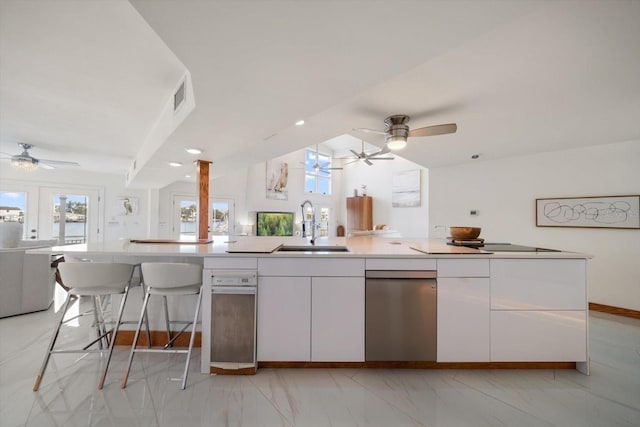 18 Winston Dr, Belleair, FL 33756 - kitchen with open floor plan, a ceiling fan, a sink, white cabinets, and lofted ceiling