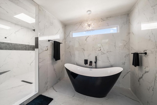 bathroom with plus walk in shower, tile walls, and a notable chandelier