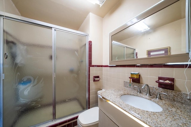 18 Winston Dr, Belleair, FL 33756 - full bath featuring vanity, tile walls, a stall shower, toilet, and a wainscoted wall