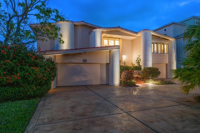 18 Winston Dr, Belleair, FL 33756 - view of front of home featuring stucco siding, a garage, and driveway