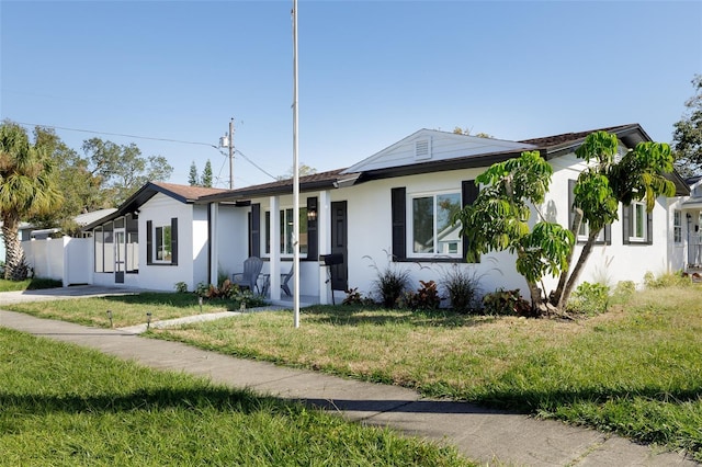 ranch-style home featuring a front yard